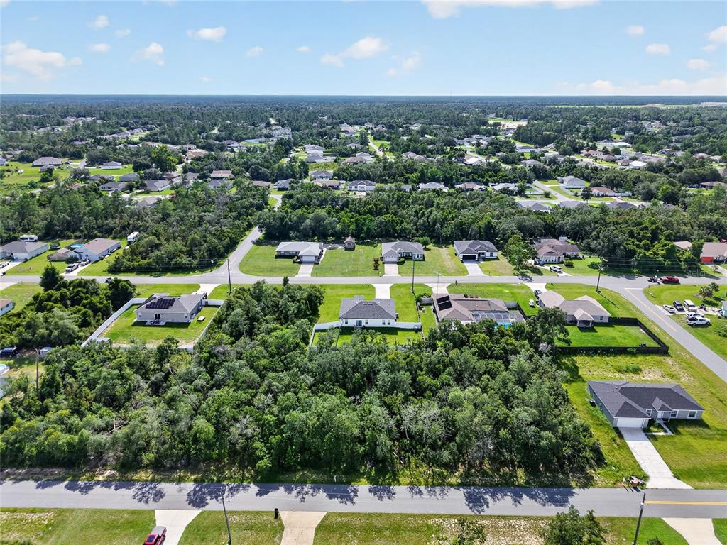 An aerial view shows several suburban houses surrounded by dense trees and green lawns — 0000 SW 42ND TERRACE, OCALA, FL