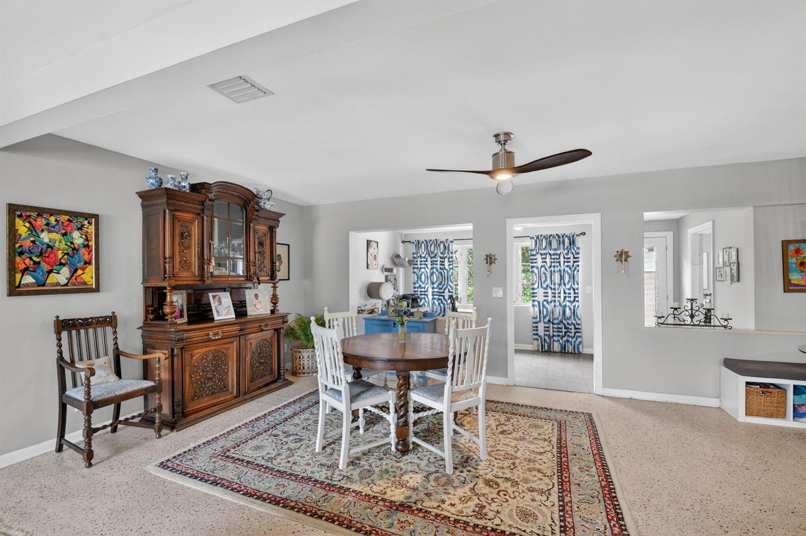 A dining area features a wooden hutch, a round table with four chairs, and a rug — 338 Edmor Road, West Palm Beach FL 33405, WEST PALM BEACH, FL