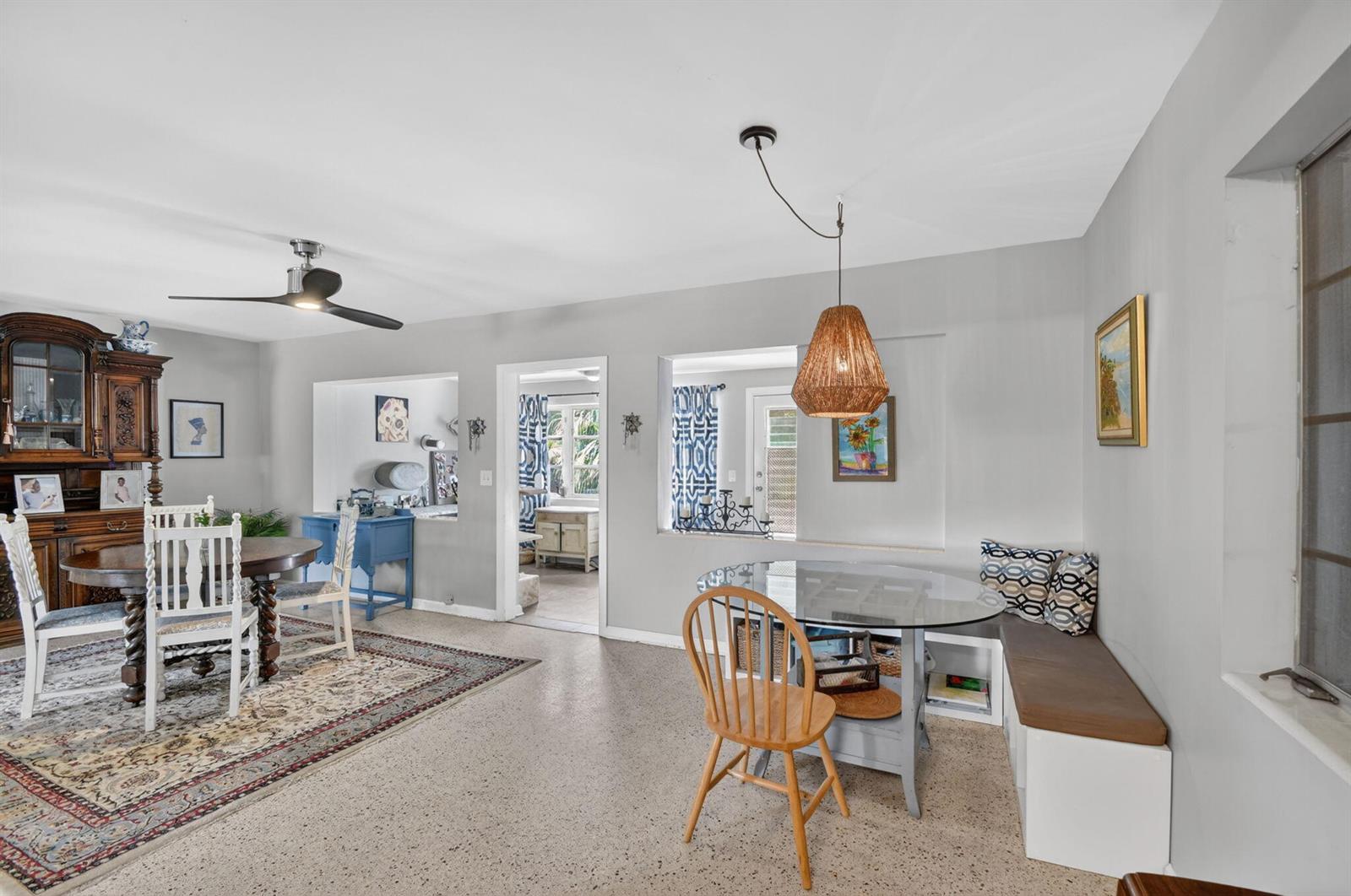 A dining room with a glass table, built-in bench seating, and a separate formal dining area — 338 Edmor Road, West Palm Beach FL 33405, WEST PALM BEACH, FL