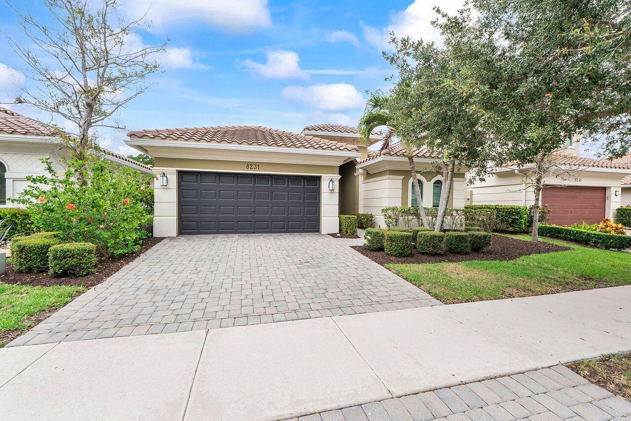 A single-story house with a paved driveway, a two-car garage, and landscaped front yard — 8231 Canopy Terrace, Parkland FL 33076, PARKLAND, FL