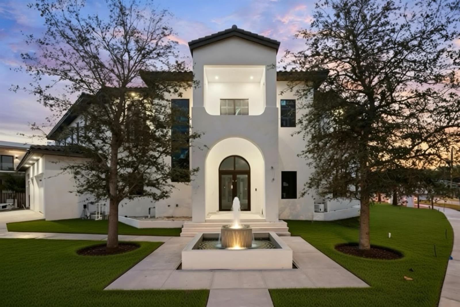 A white two-story house with a central arched entryway and a front fountain — 298 NE 8th Street, Boca Raton FL 33432, BOCA RATON, FL