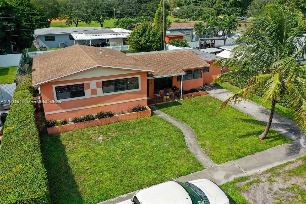 An aerial view shows a single-story orange house with a brown roof and front lawn — 17800 NW 14th Pl, Miami Gardens FL 33169, MIAMI GARDENS, FL