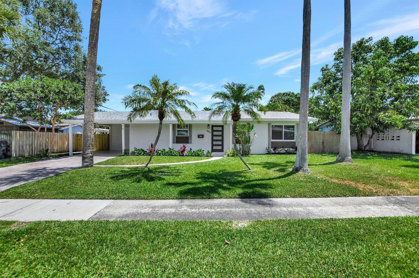 A single-story house with a white exterior, palm trees, and a paved driveway — 832 SW 10th Avenue, Boca Raton FL 33486, BOCA RATON, FL