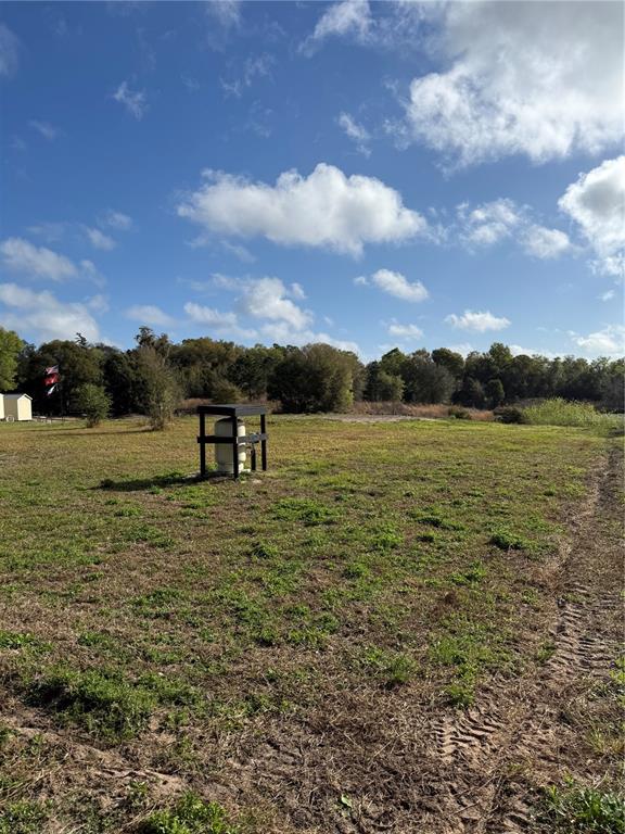 A water well pressure tank sits on a wooden frame in a grassy field — 1043 HAZEN ROAD, DELAND, FL