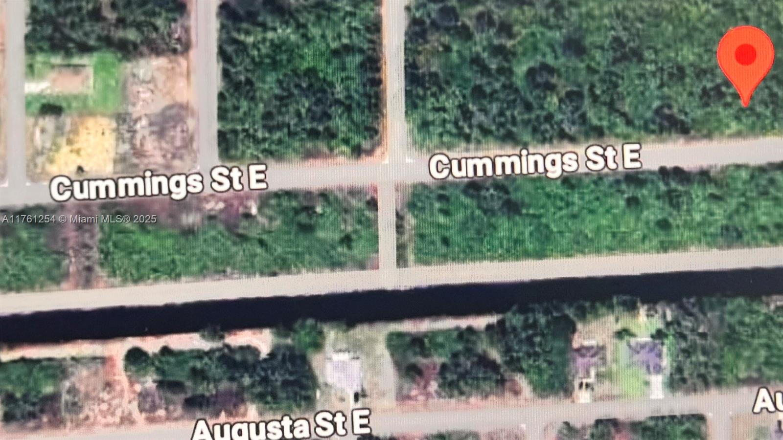 This is a satellite map view showing residential lots along Cummings St E and Augusta St E — 1245 E Cummings St, Lehigh Acres FL 33974, LEHIGH ACRES, FL