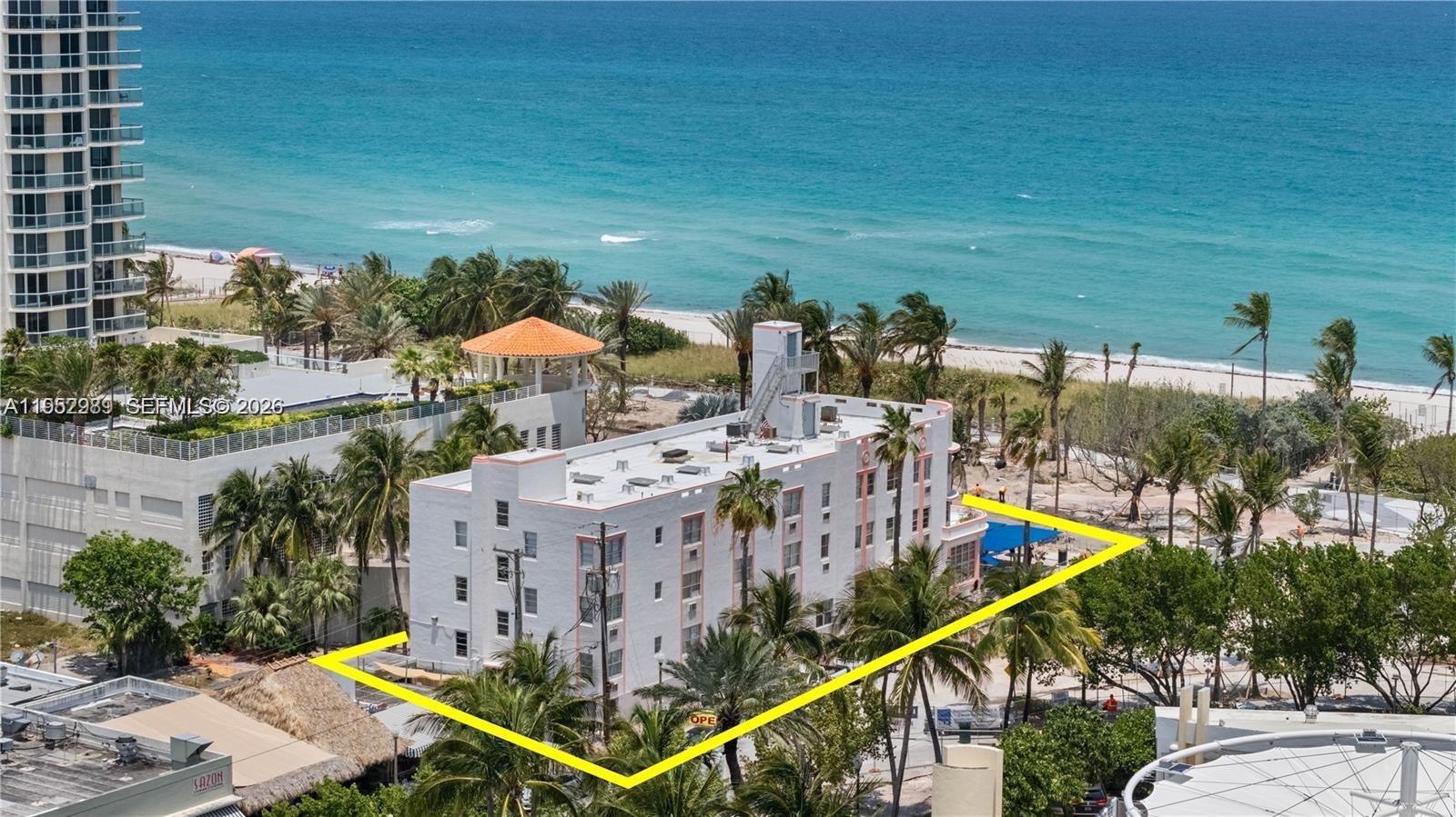 An aerial view shows a multi-story white building near a beach with a yellow outline — 7300 Ocean Ter, Miami Beach FL 33141, MIAMI BEACH, FL