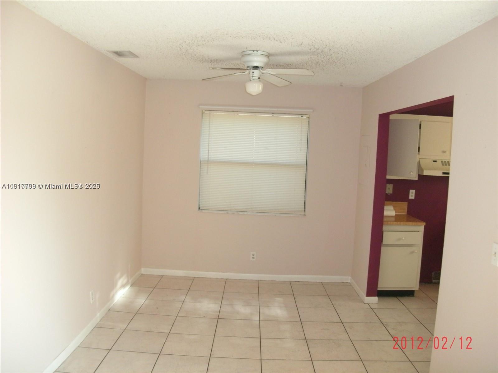 A dining area with tile flooring, a ceiling fan, and an adjacent kitchen — 1318 White Pine Dr, Wellington FL 33414, WELLINGTON, FL