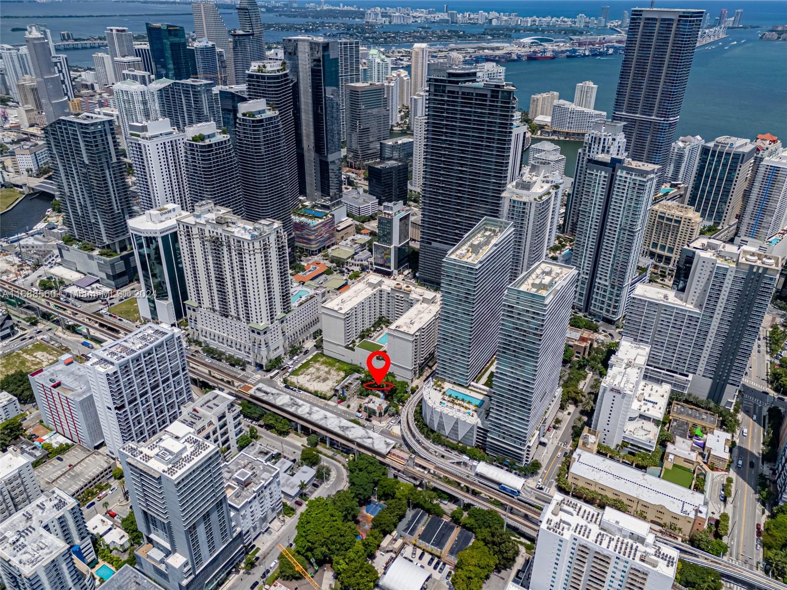 An aerial view shows a dense urban cityscape with a red location pin marking a lot — 75 SW 11th St, Miami FL 33130, MIAMI, FL