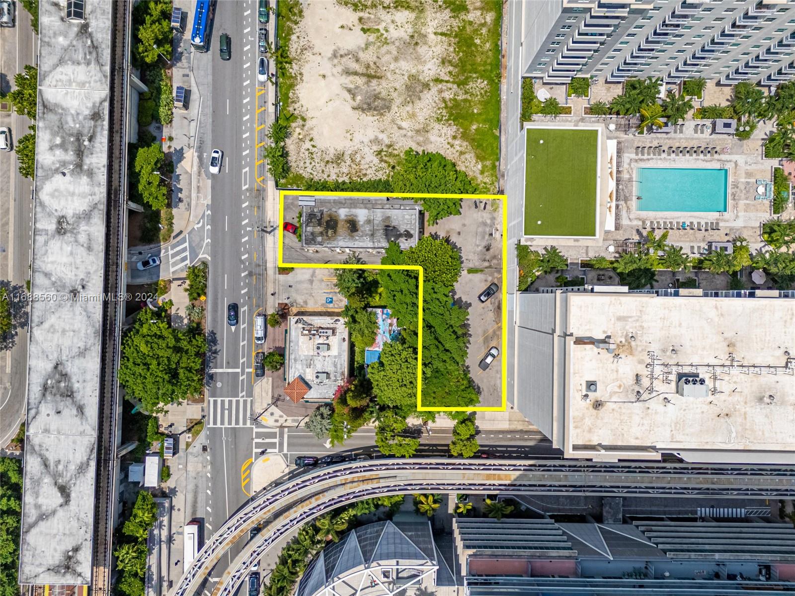 This aerial view shows a rectangular urban lot outlined in yellow with two existing buildings — 75 SW 11th St, Miami FL 33130, MIAMI, FL