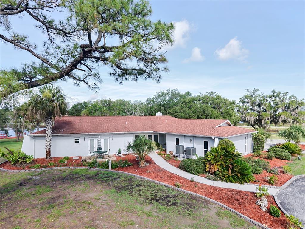 An aerial view of a single-story house with a red roof and a paved driveway — 11580 W DIXIE SHORES DRIVE, CRYSTAL RIVER, FL
