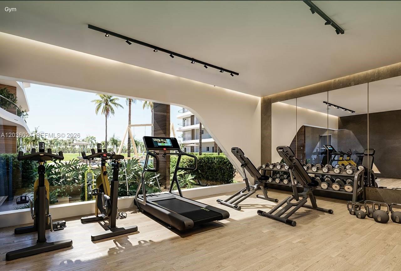 This rendering shows a modern gym with exercise equipment, wood flooring, and a large outdoor view — 0 coral golf # 0, FL