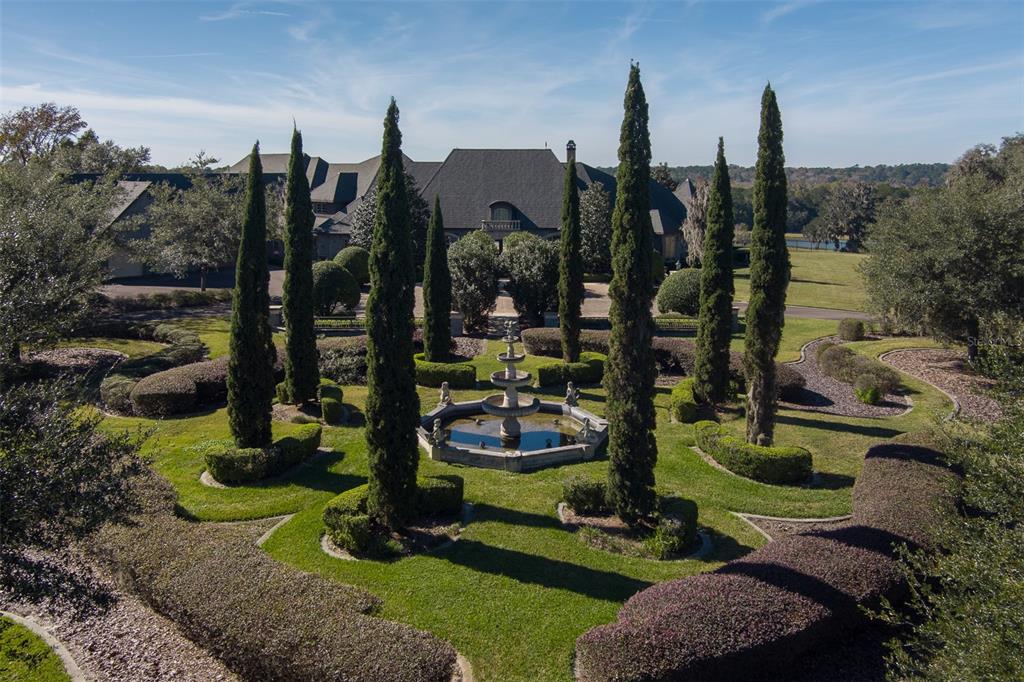 An aerial view of a large house with a formal garden and a central fountain — 9001 NW 200TH STREET ROAD, MICANOPY, FL