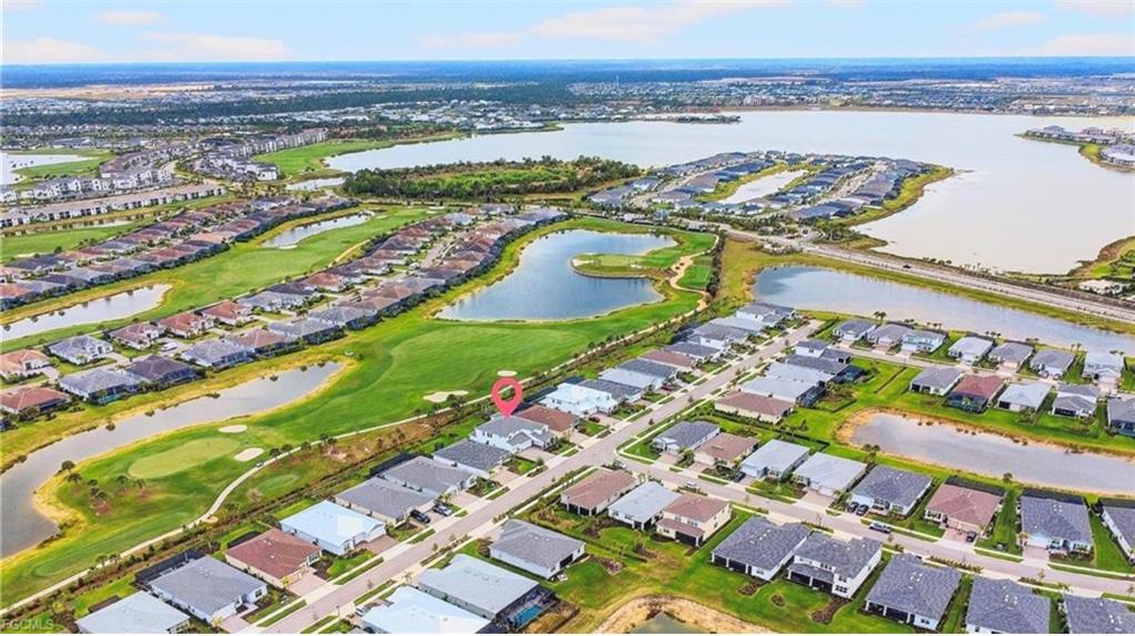 An aerial view shows a residential neighborhood with a marked house near a golf course — 15776 APPALACHIAN DRIVE, PUNTA GORDA, FL