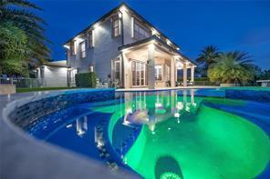 A two-story house with a lit swimming pool in the foreground at twilight — 5422 SW 185th Terrace, Miramar FL 33029, MIRAMAR, FL