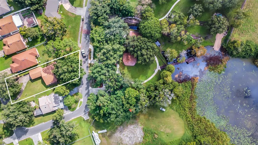 An aerial view shows a residential property with a house, driveway, and surrounding trees — 209 BAYSHORE DRIVE, ORLANDO, FL