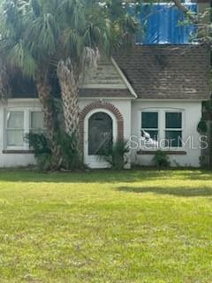 A white house with a brown roof, arched entryway, and a palm tree in front — 3835 8TH STREET S, ST PETERSBURG, FL