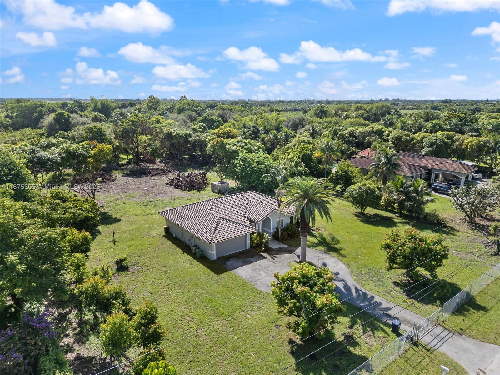 An aerial view shows a single-story house with a tiled roof and a large yard — 16035 SW 173rd Ave, Miami FL 33187, MIAMI, FL
