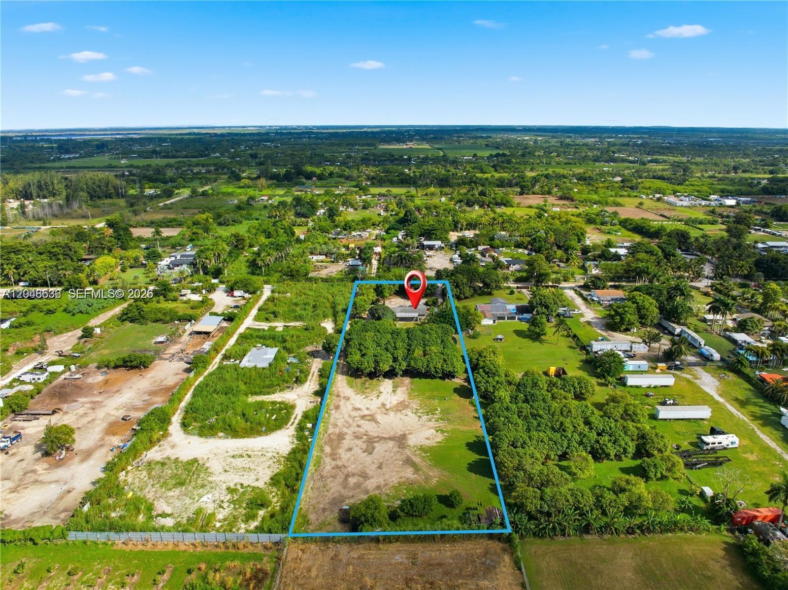 An aerial view shows a rectangular property lot outlined in blue with a house and trees — 15490 SW 209th Ave, Miami FL 33187, MIAMI, FL