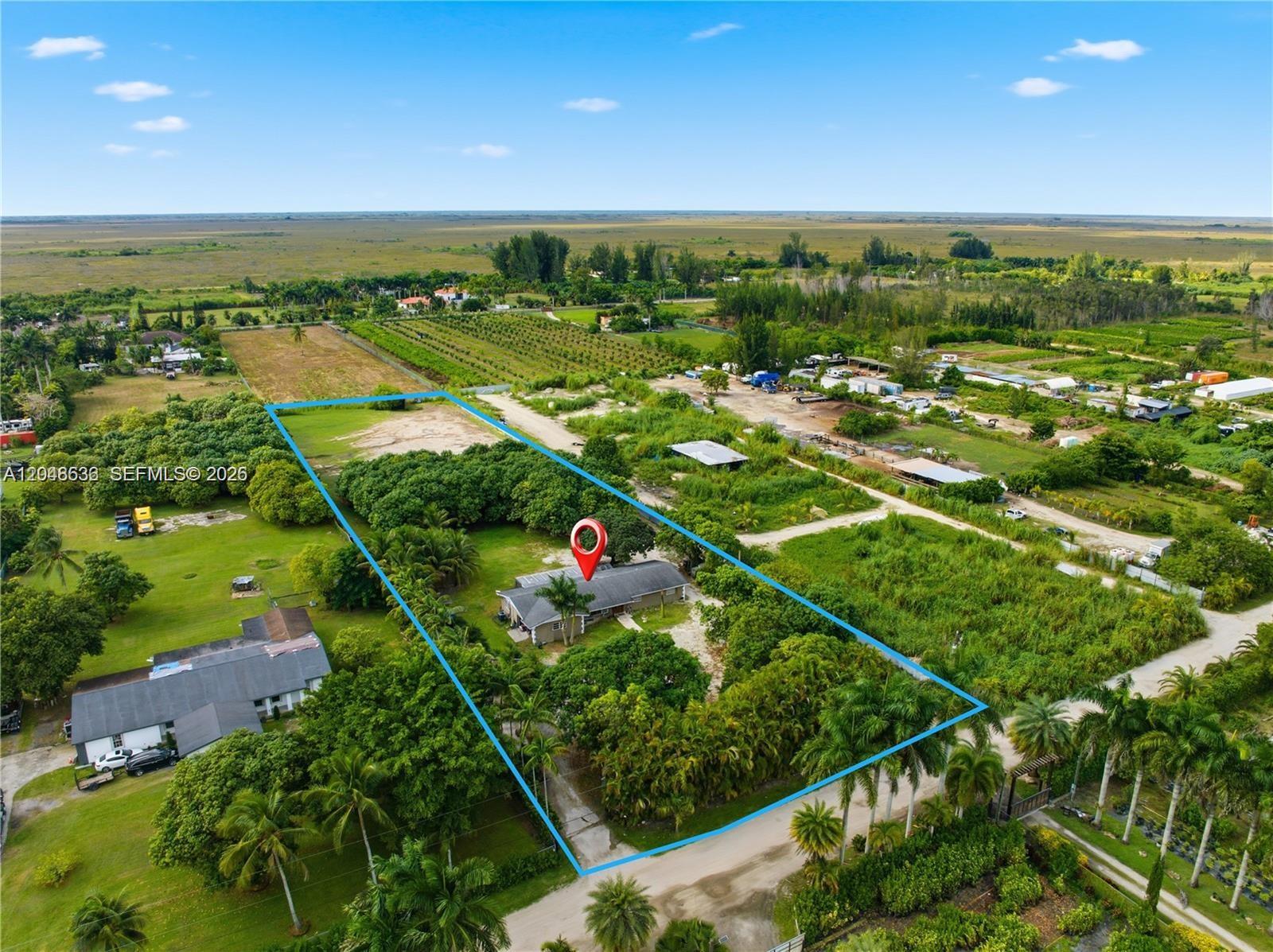 An aerial view shows a house on a large, tree-filled lot outlined in blue — 15490 SW 209th Ave, Miami FL 33187, MIAMI, FL
