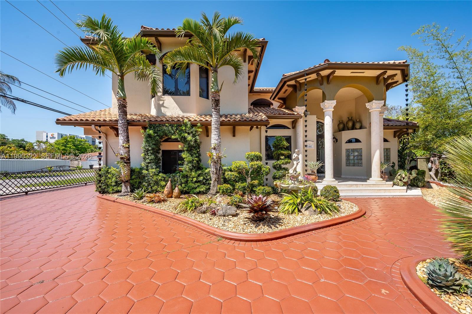 A two-story stucco house features a tiled roof, palm trees, and a patterned driveway — 588 Miller Dr, Miami Springs FL 33166, MIAMI SPRINGS, FL