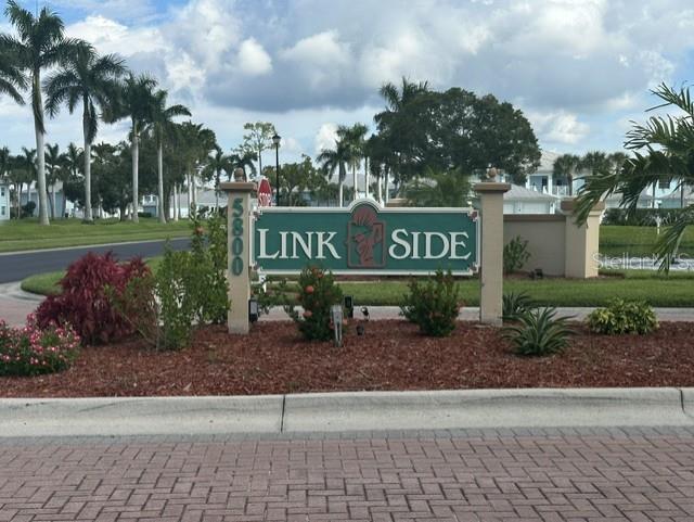 A sign for Link Side stands in a landscaped garden with palm trees in the background — 5800 SABAL TRACE DRIVE UNIT 603, NORTH PORT, FL