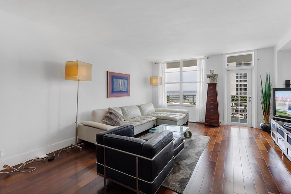 A living room features a white sectional sofa, a black leather chair, and ocean views — 2851 S Ocean Boulevard # C, Boca Raton FL 33432, BOCA RATON, FL