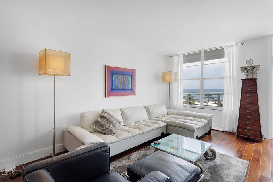 A living room features a white sectional sofa, a glass coffee table, and ocean views — 2851 S Ocean Boulevard # C, Boca Raton FL 33432, BOCA RATON, FL