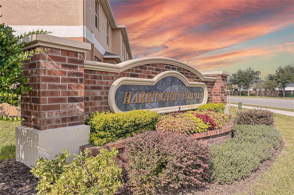 A brick monument sign for Harrington Pointe stands in front of a multi-story apartment building — 3610 RODRICK CIRCLE, ORLANDO, FL