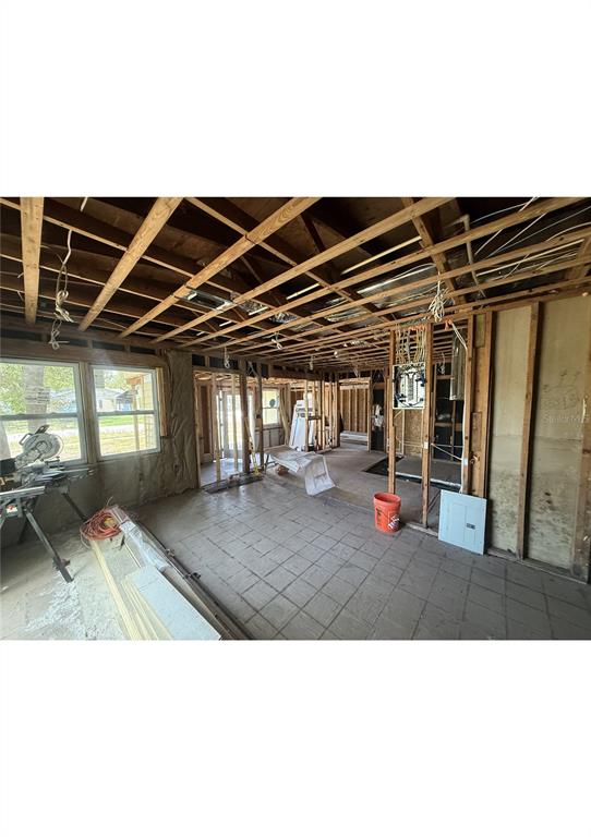 An interior view of a house under renovation with exposed ceiling joists and wall studs — 4730 W WALLACE AVENUE, TAMPA, FL