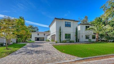 A two-story white house with a brick driveway and a large green lawn — 1850 WEBBER STREET, SARASOTA, FL