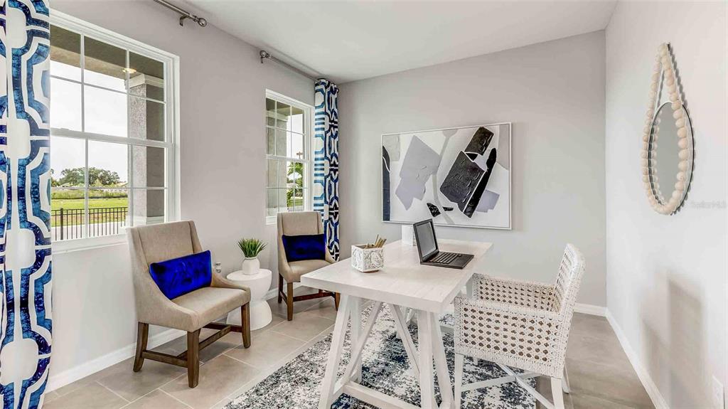 A home office features a white desk, two beige chairs, a woven chair, and patterned curtains — 35630 LOWERY TRAIL, ZEPHYRHILLS, FL
