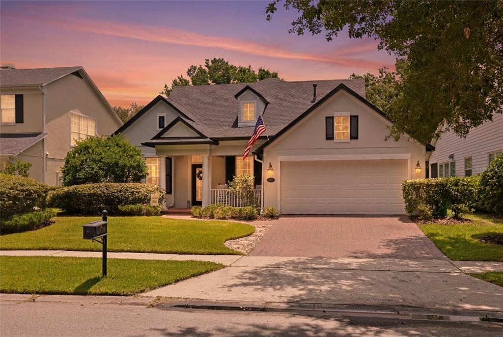 A single-story house with a white garage, a front porch, and a paved driveway — 103 ASTERBROOKE DRIVE, DELAND, FL