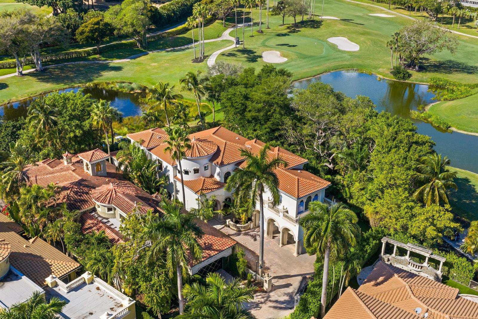 An aerial view of a large Mediterranean-style house with a tile roof near a golf course — 422 Addison Park Lane, Boca Raton FL 33432, BOCA RATON, FL