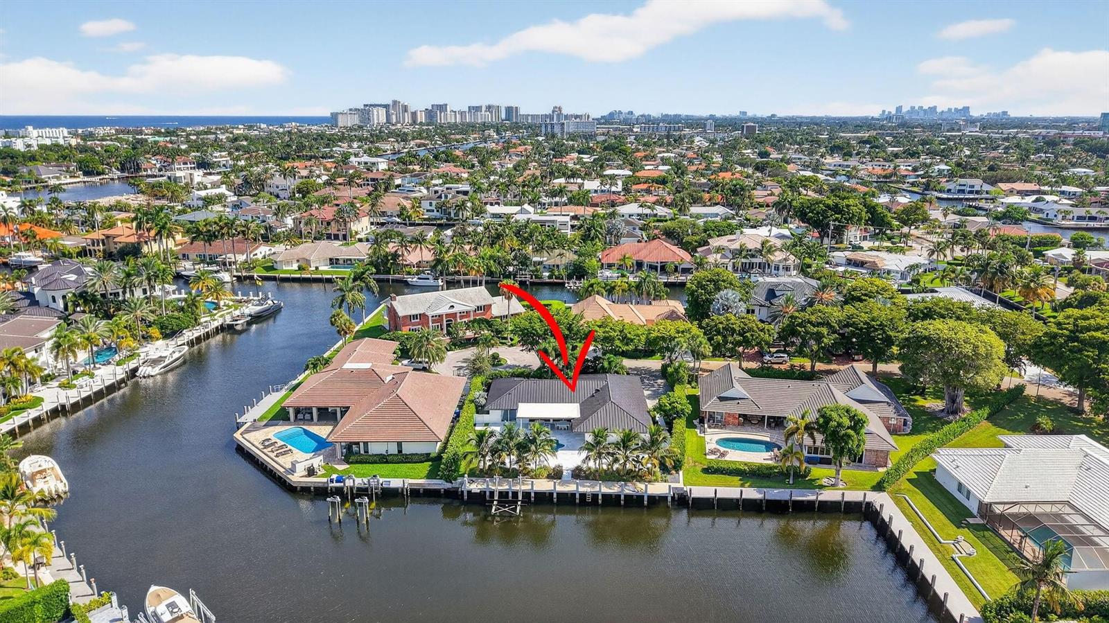 An aerial view shows a waterfront house with a dark roof, pool, and boat dock — 41 S Compass Drive, Fort Lauderdale FL 33308, FORT LAUDERDALE, FL