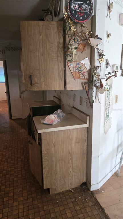 A kitchen area features wood-grain cabinets, a laminate countertop, and a checkered floor — 220 MOUNT PLEASANT ROAD, NOKOMIS, FL