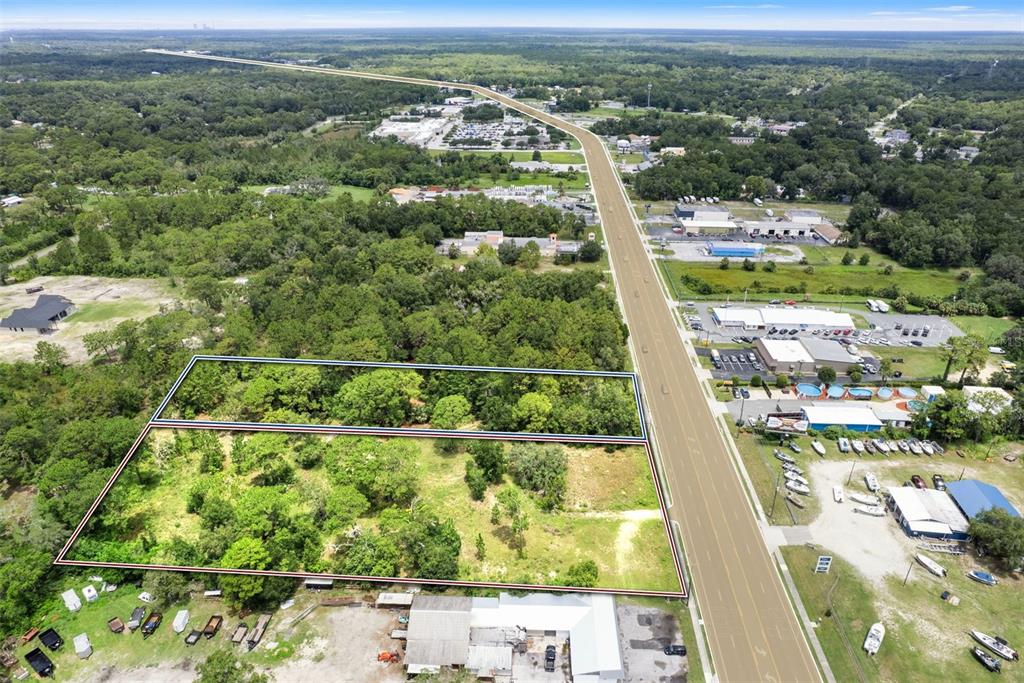 An aerial view shows two adjacent vacant lots bordering a multi-lane highway — 6574 W GULF TO LAKE HIGHWAY, CRYSTAL RIVER, FL