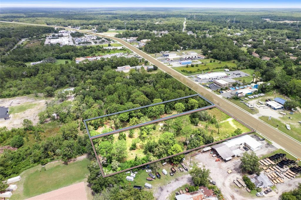 An aerial view shows two adjacent rectangular plots of land bordering a paved road — 6574 W GULF TO LAKE HIGHWAY, CRYSTAL RIVER, FL