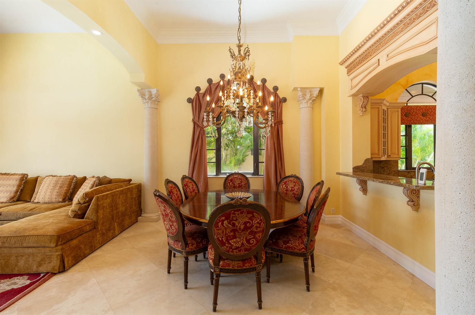 A dining area with a round wooden table, ornate chairs, and a crystal chandelier — 529 Pelican Way, Delray Beach FL 33483, DELRAY BEACH, FL