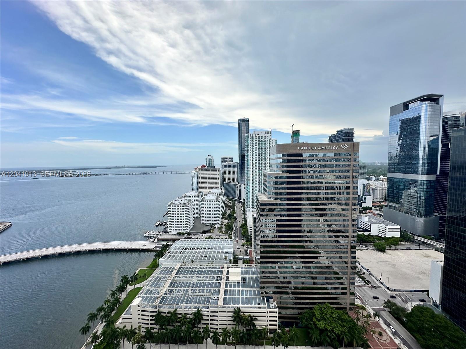 A high-angle view shows the Miami skyline, the Rickenbacker Causeway, and Biscayne Bay — 495 Brickell Ave # 4011, Miami FL 33131, MIAMI, FL