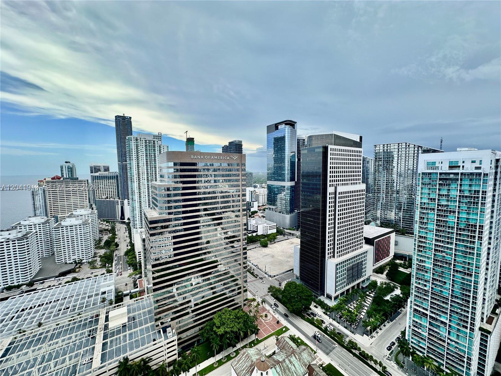 An elevated view of a dense city skyline featuring several modern glass skyscrapers — 495 Brickell Ave # 4011, Miami FL 33131, MIAMI, FL