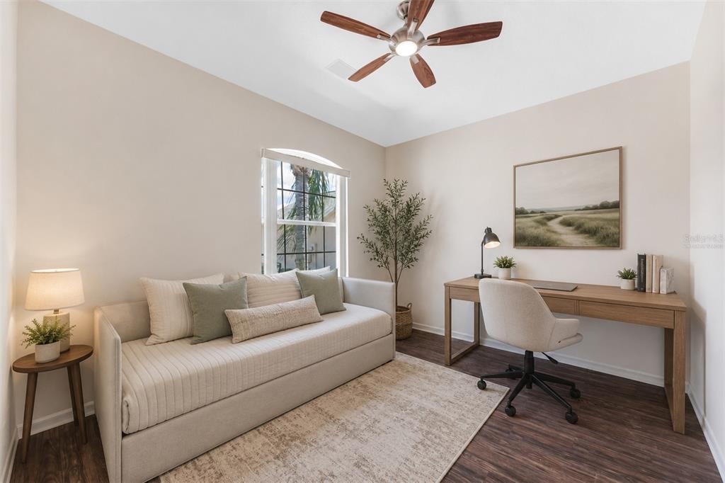 A home office features a daybed, a wooden desk with a chair, and a ceiling fan — 1149 EMERALD DUNES DRIVE, SUN CITY CENTER, FL
