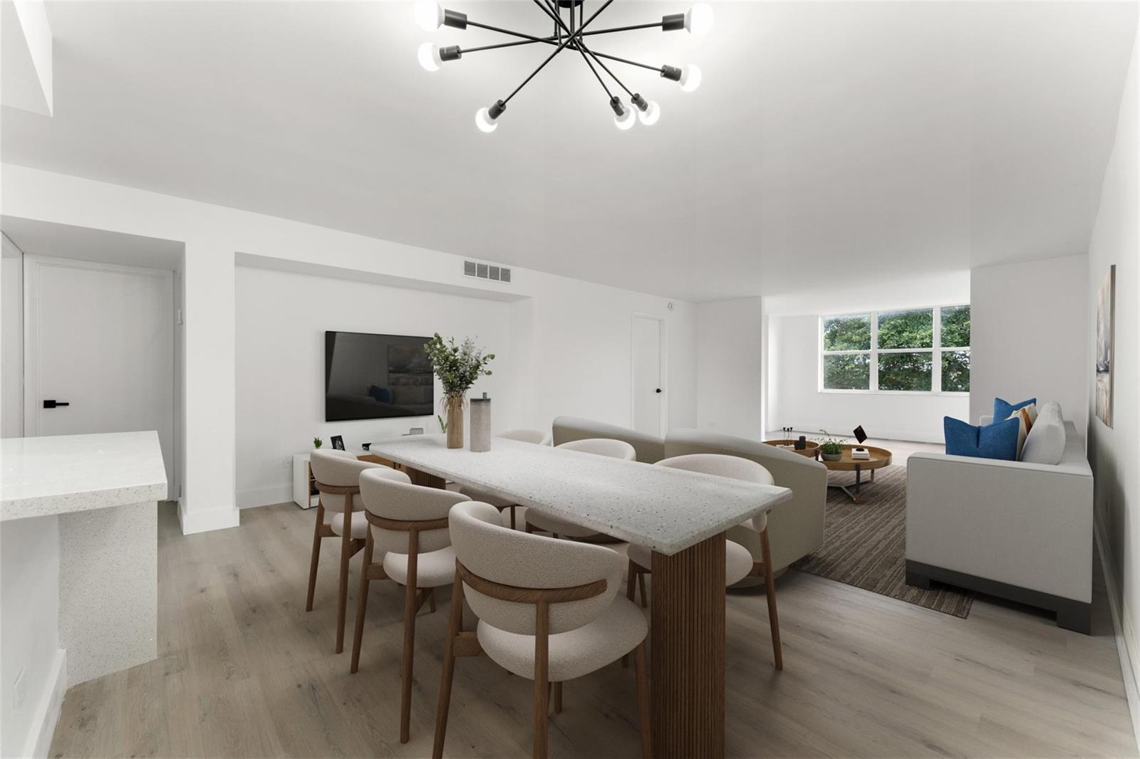 A modern open-concept living and dining area features light wood floors and a stone table — 441 NE 195th Street # 302, Miami FL 33179, MIAMI, FL