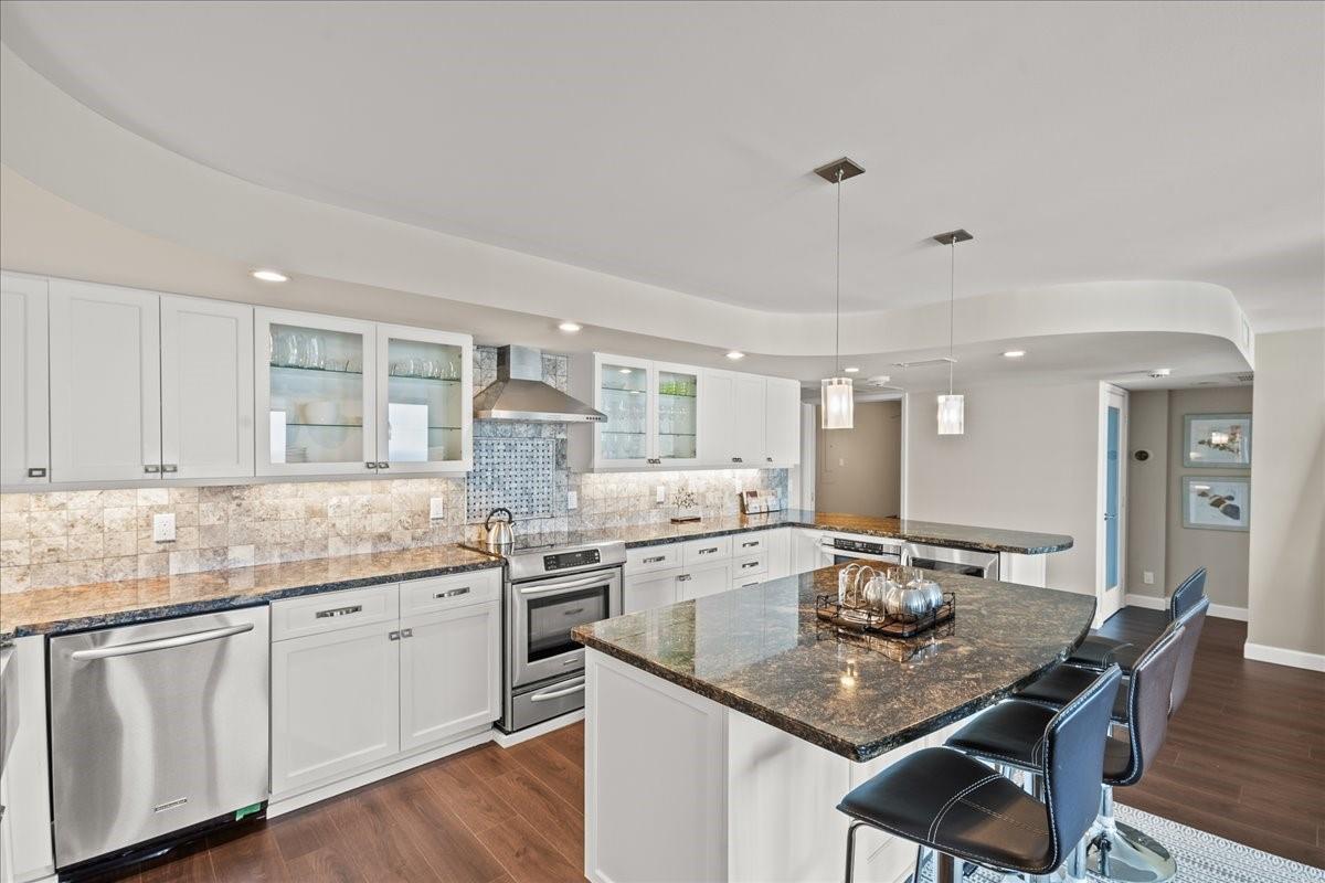 A kitchen with white cabinets, granite countertops, stainless steel appliances, and a central island — 1890 S Ocean Drive, Hallandale Beach FL 33009, HALLANDALE BEACH, FL