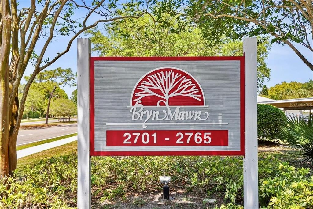 A sign for Bryn Mawn stands outdoors surrounded by trees and landscaping — 2749 COUNTRYSIDE BOULEVARD UNIT 22, CLEARWATER, FL