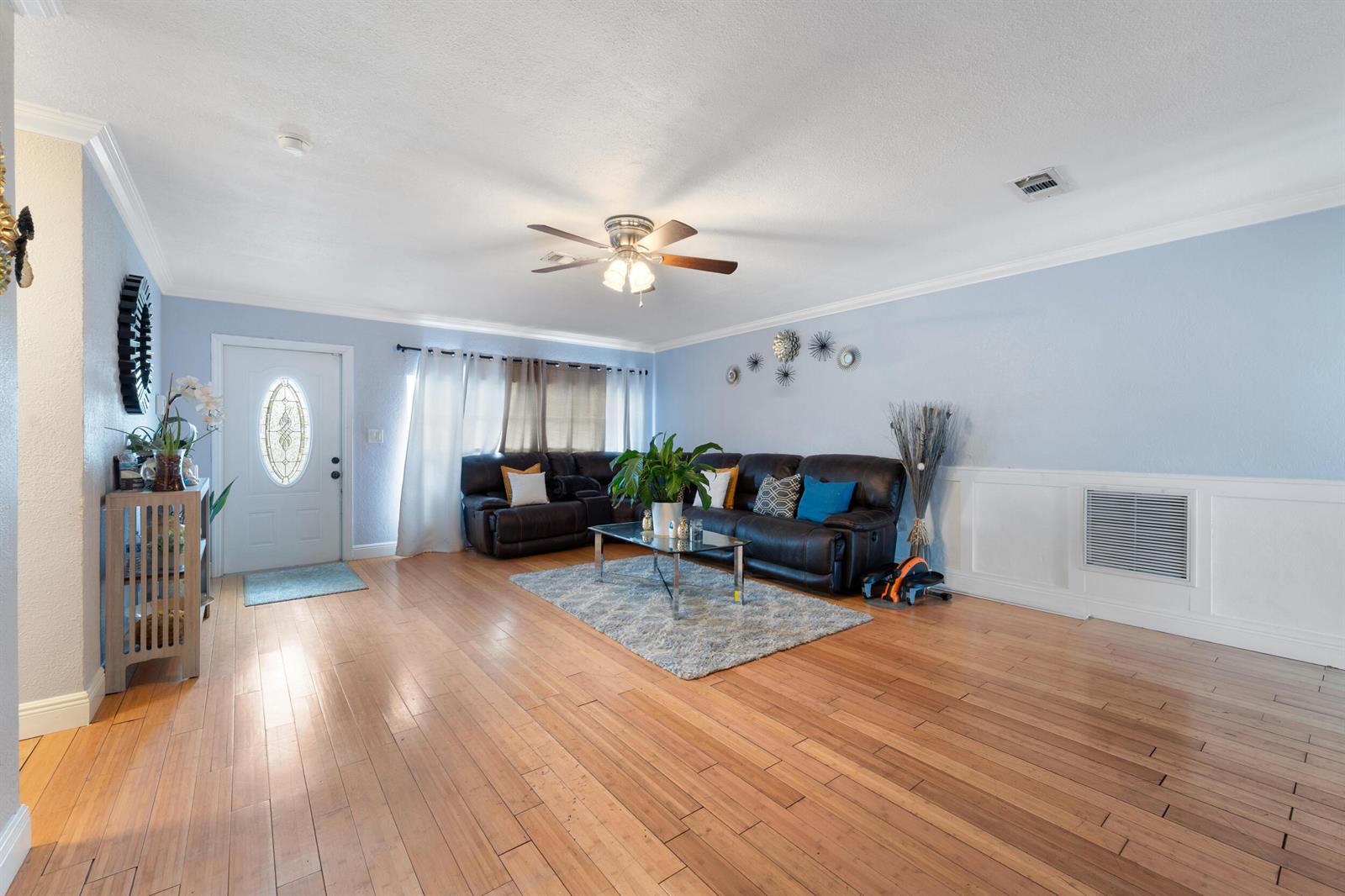 A living room features light blue walls, hardwood floors, a sectional sofa, and a ceiling fan — 808 Wright Drive, Lake Worth FL 33461, LAKE WORTH, FL