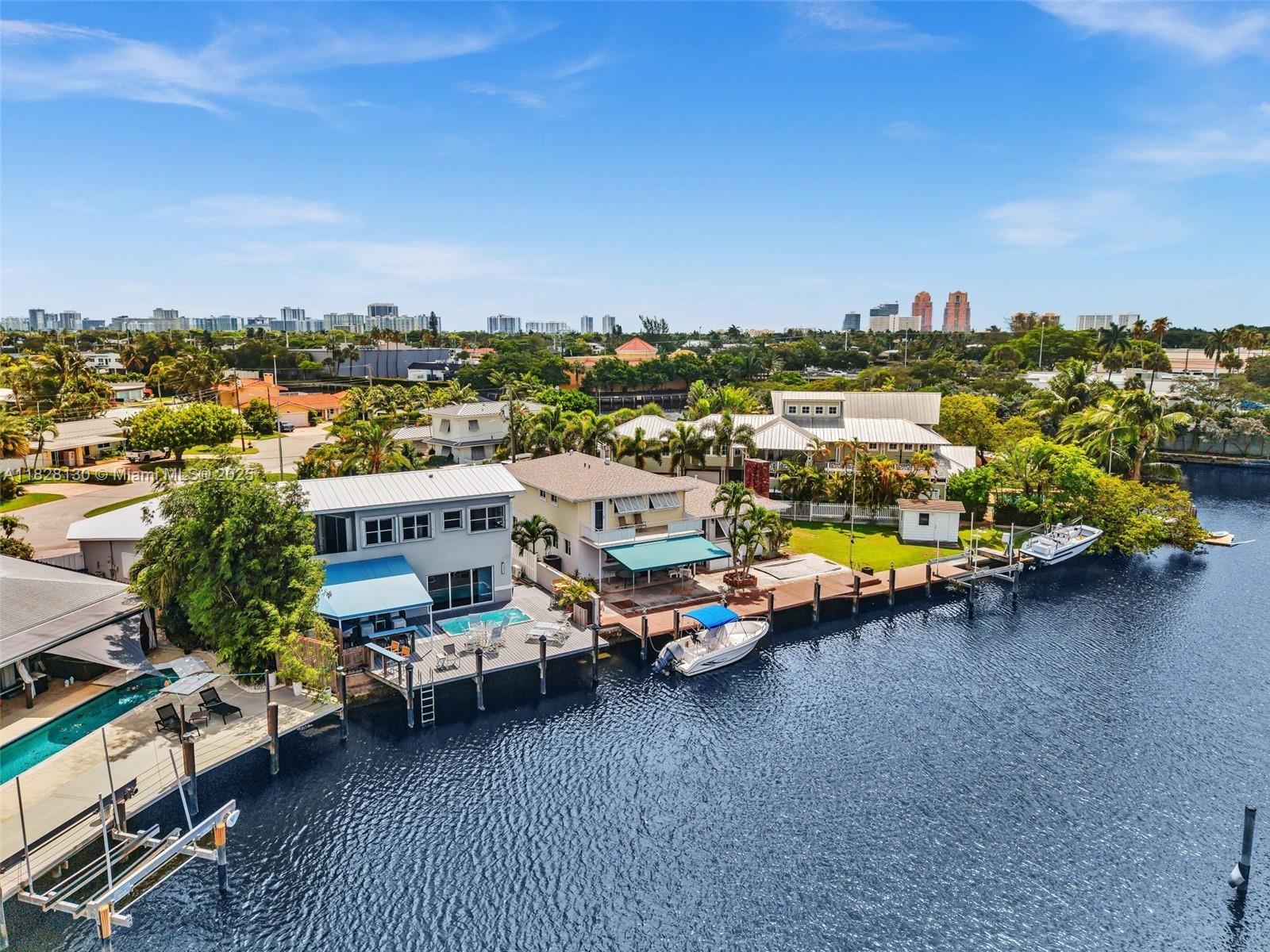An aerial view shows waterfront houses with private docks, boats, and pools along a canal — 2108 NE 24th St, Wilton Manors FL 33305, WILTON MANORS, FL