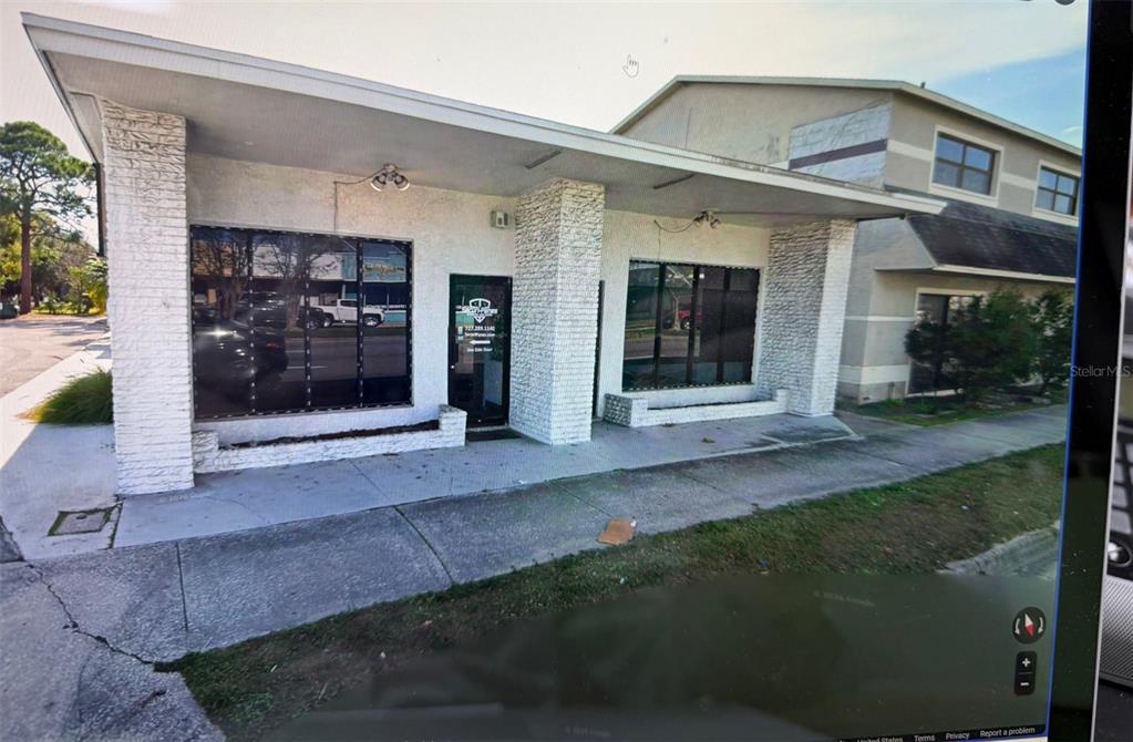 A single-story commercial building with white stone pillars and large glass windows under an overhang — 5630 PARK BOULEVARD N UNIT A & B, PINELLAS PARK, FL
