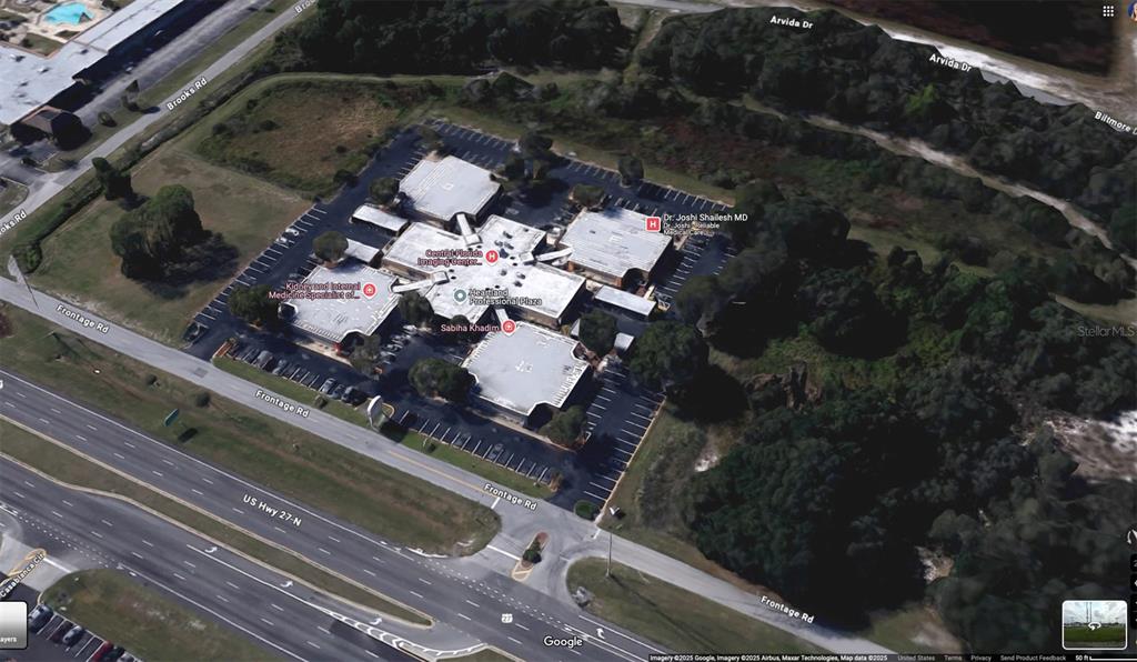 An aerial satellite view shows a commercial office complex with parking lots and surrounding vegetation — 6801 US HIGHWAY 27 N, SEBRING, FL