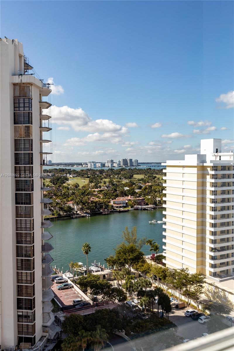An elevated view shows a waterway between two high-rise buildings with a distant city skyline — 5445 Collins Ave # 1108, Miami Beach FL 33140, MIAMI BEACH, FL