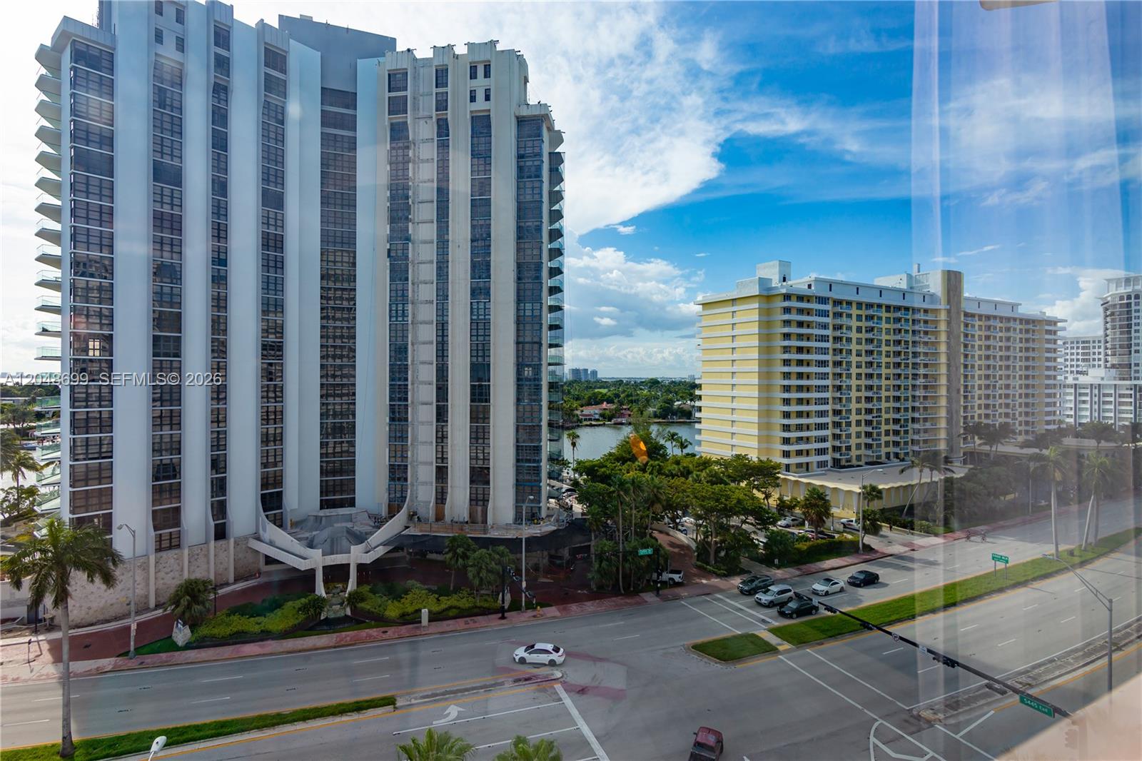 An elevated view shows two large residential high-rise buildings separated by a street and trees — 5445 Collins Ave # 1108, Miami Beach FL 33140, MIAMI BEACH, FL